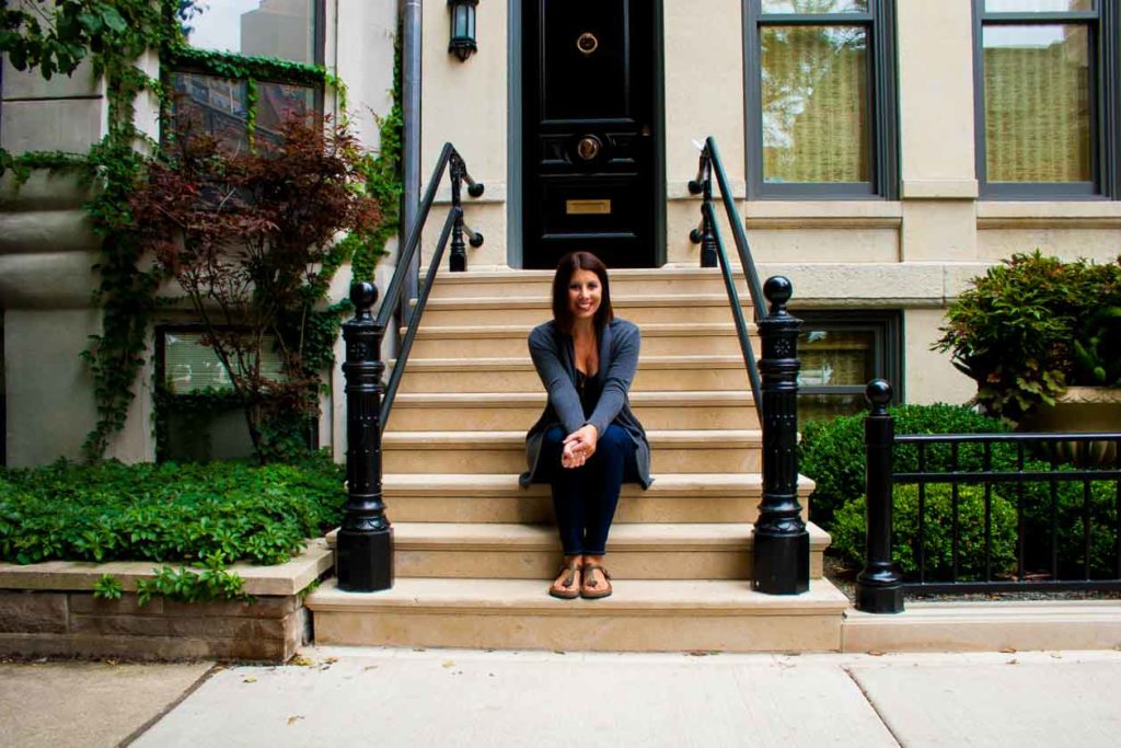 woman sitting on the stairs and sharing Transitional Pieces Summer to Fall