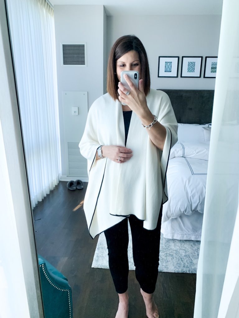 woman taking a selfie wearing maternity capsule wardrobe