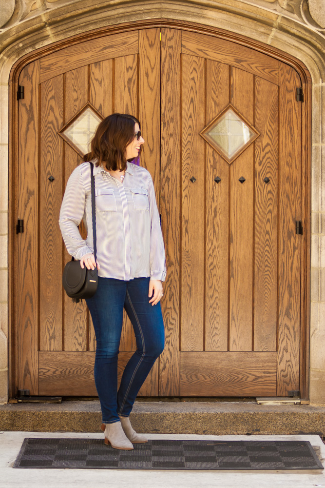 woman wearing striped utility blouse and jeans