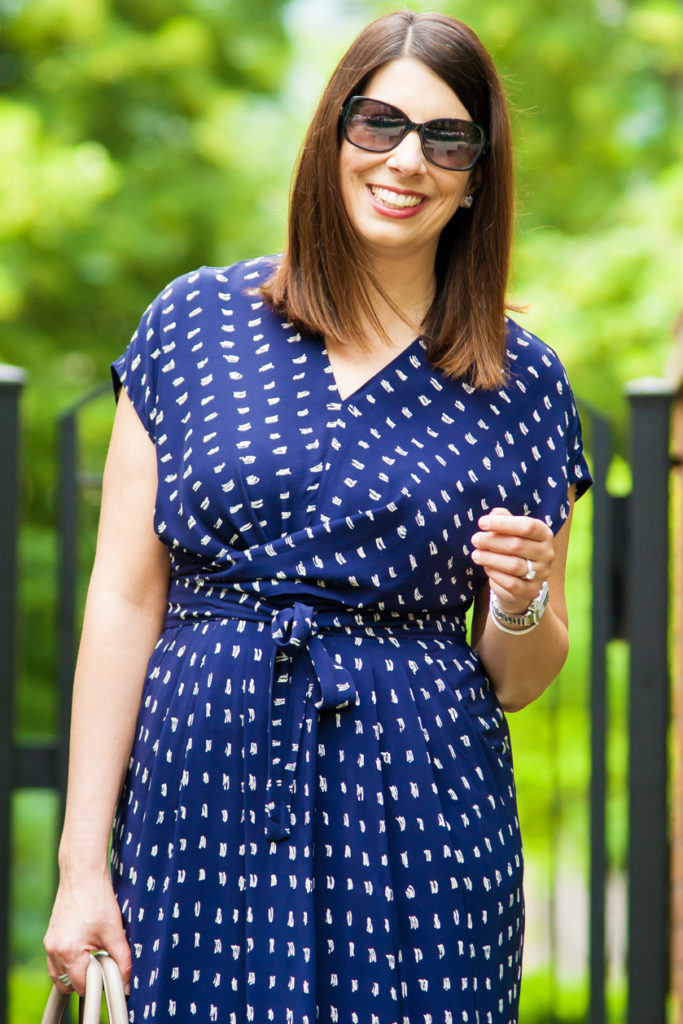 woman smiling and wearing blue dress