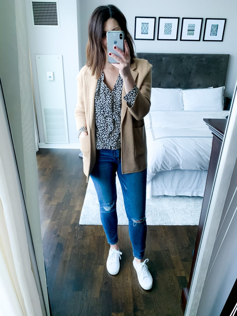 woman wearing black and white leopard print ruffle, skirt, jacket, and denim pants which is one of the ways to wear one top 3 ways 