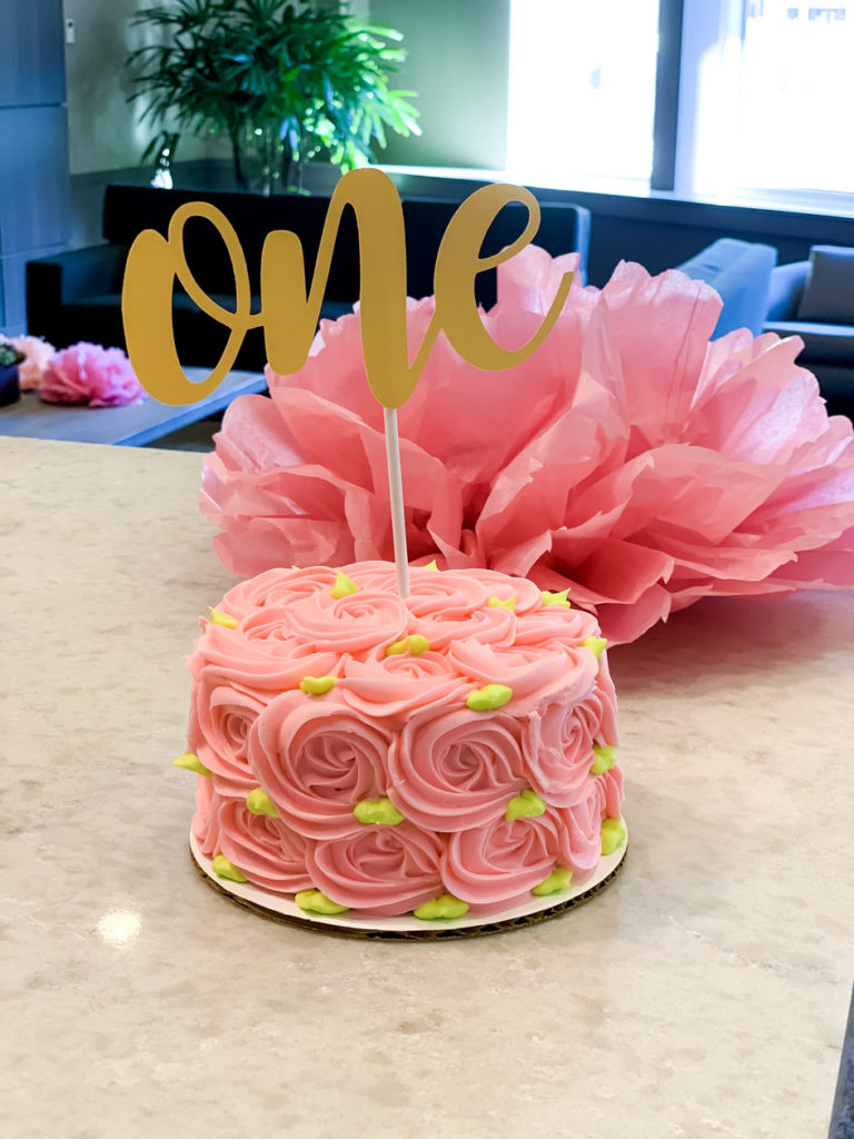 pink cake with one sign for first birthday party ideas