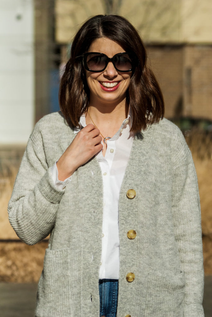 woman wearing white relaxed blouse for winter wardrobe staples 