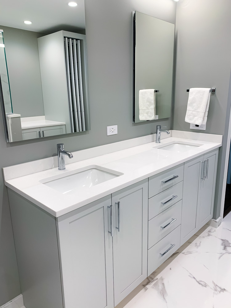 master bathroom remodel with two white sinks, cabinets, and two mirrors