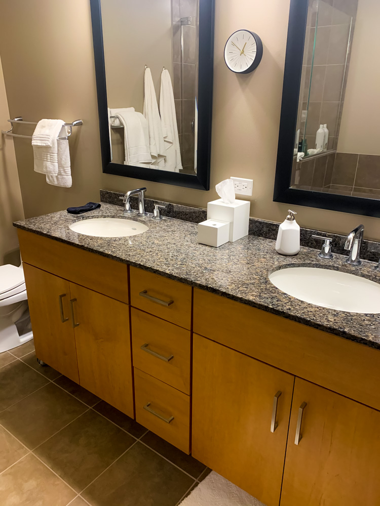 two bathroom sinks with toiletries on top 