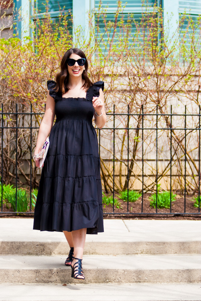 woman wearing black dress, sunglasses, and sandals for Nap Dress Review