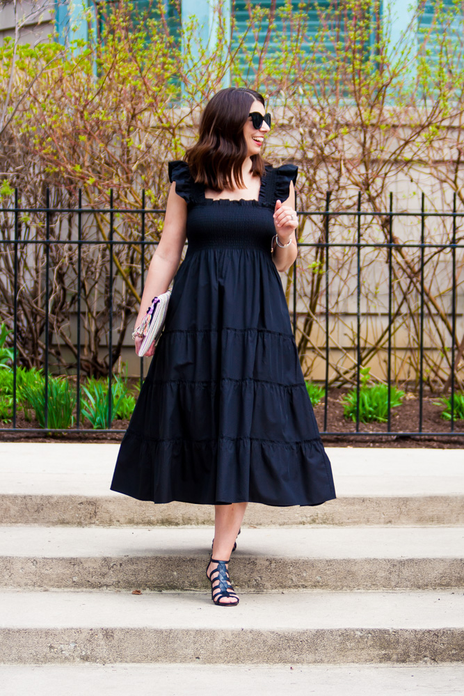 woman wearing black dress, sunglases, and sandals for Nap Dress Review