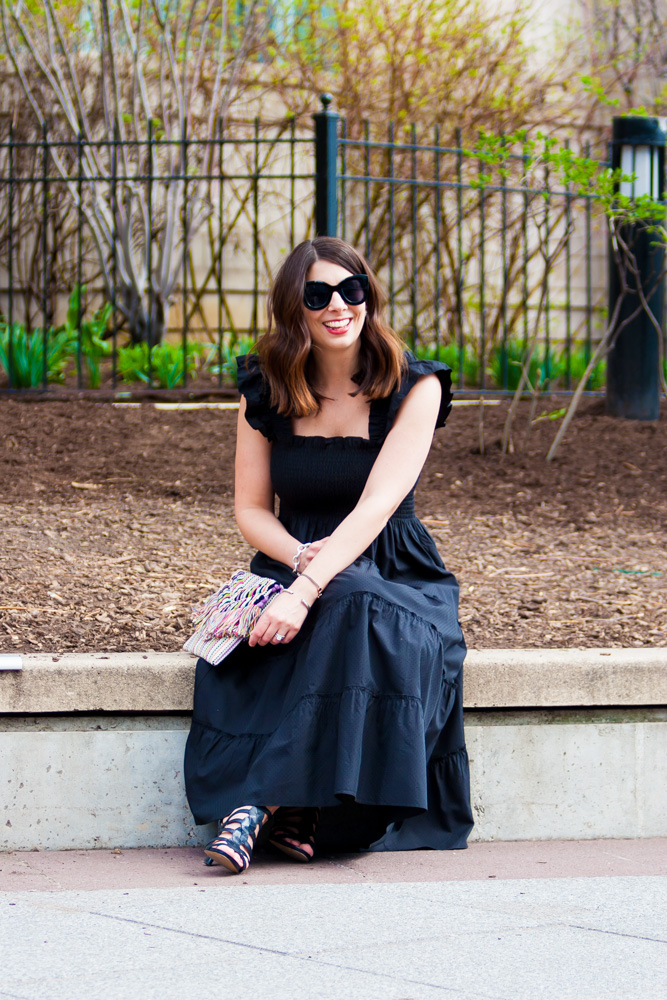 woman sitting down wearing a black dress for 