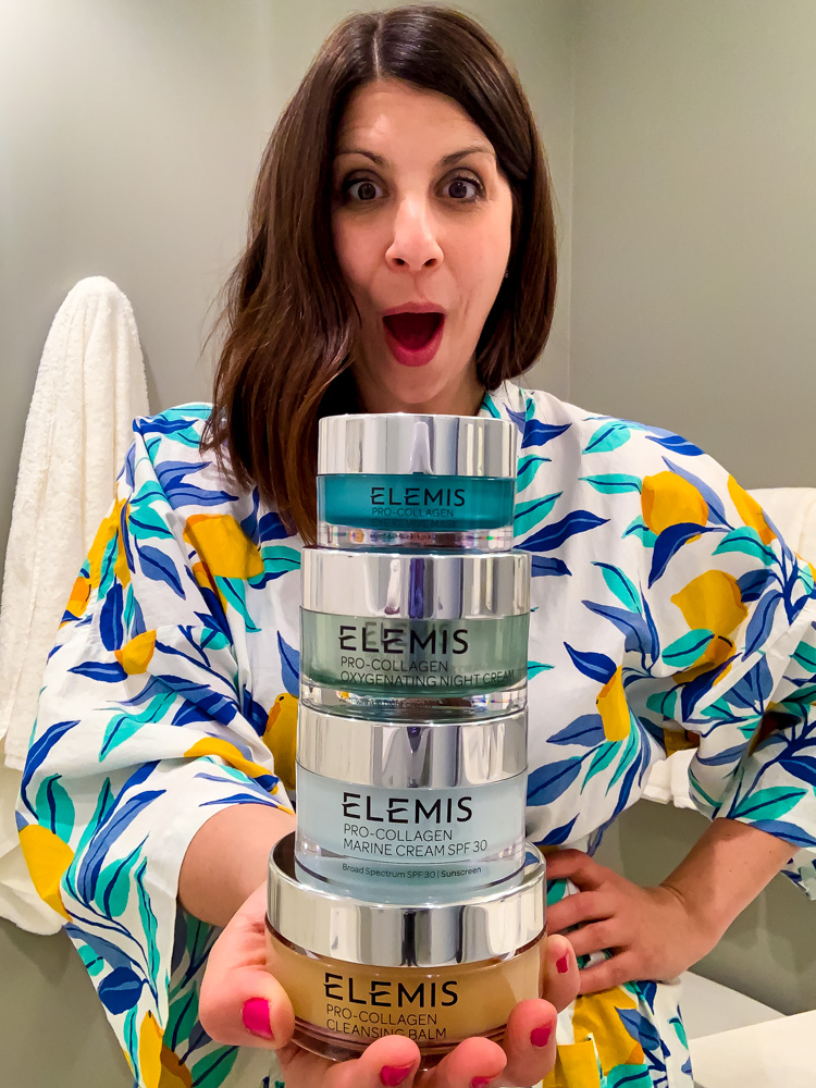 woman holding a stack of ELEMIS beauty routine