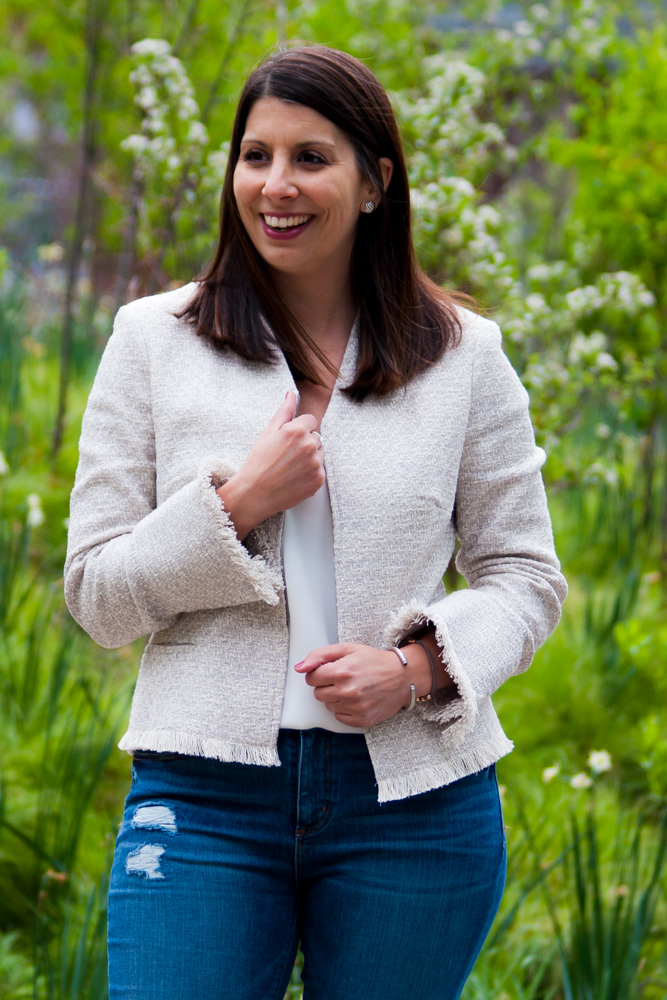 woman smiling and wearing jacket and jeans