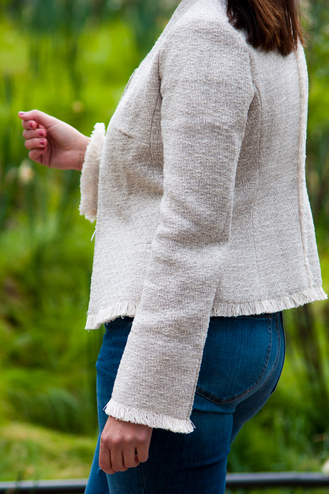 woman wearing tweed blazer and jeans