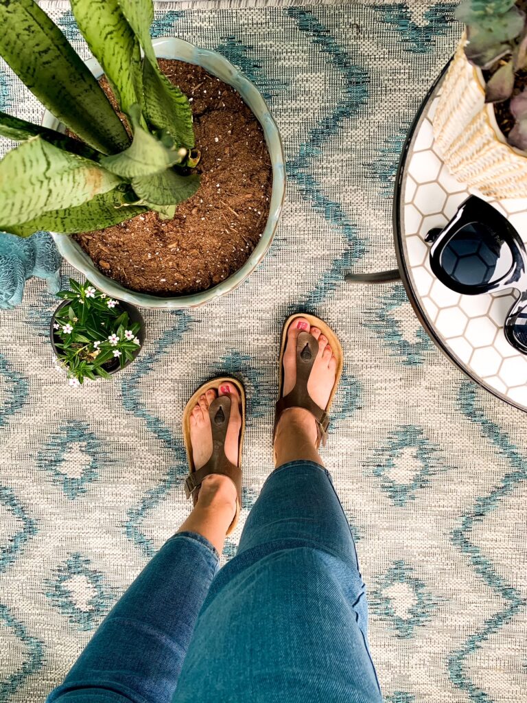 woman wearing Birkenstock Sandals and denim jeans