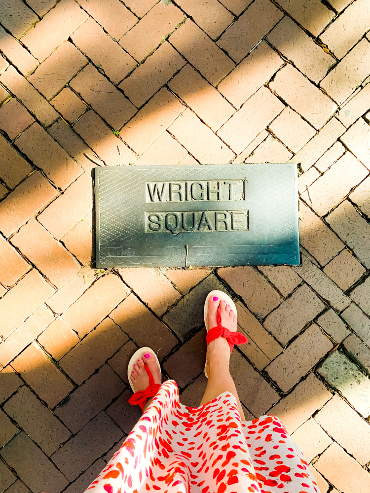 woman standing near the wright square signage