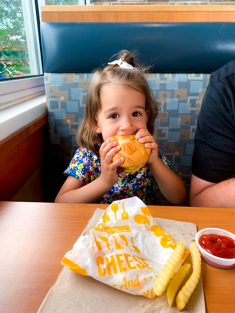 kid biting a burger and celebrating Father's Day At Culver's