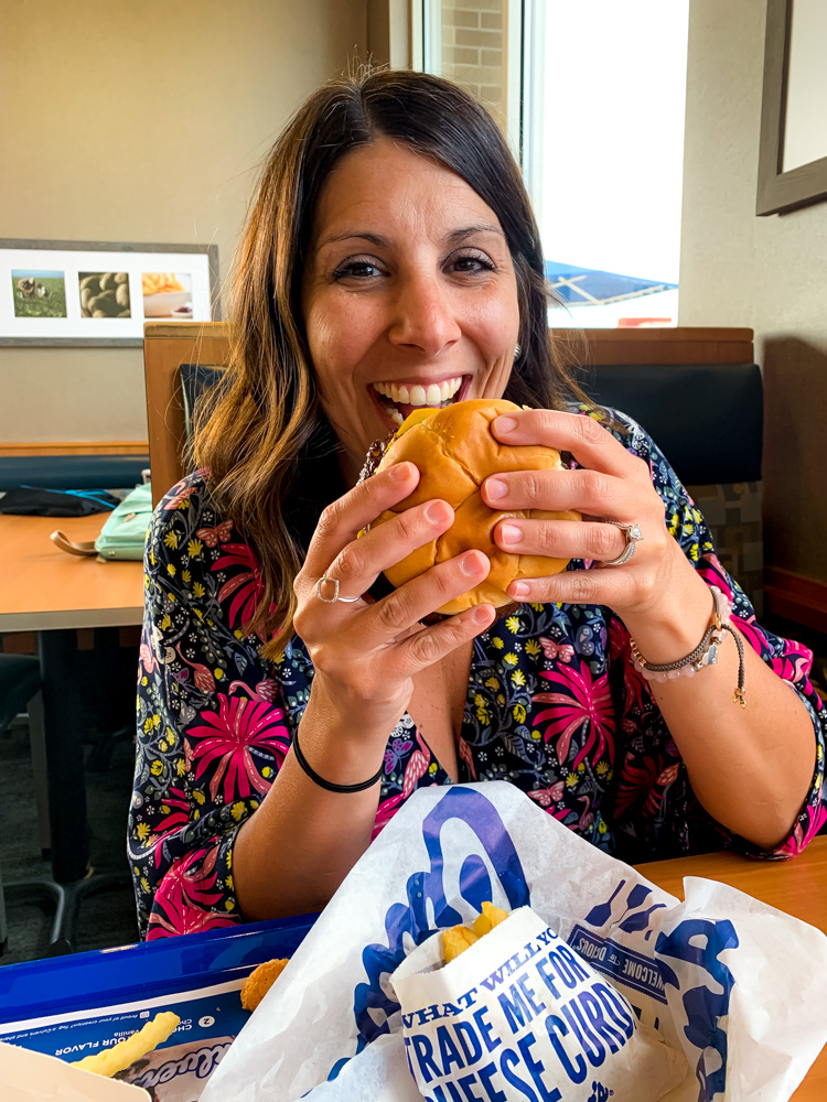 woman earing a burger celebrating Father's Day At Culver's