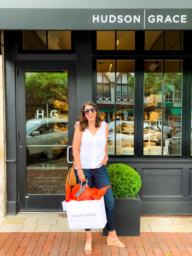 woman outside the hudson grace and holding a paper bag