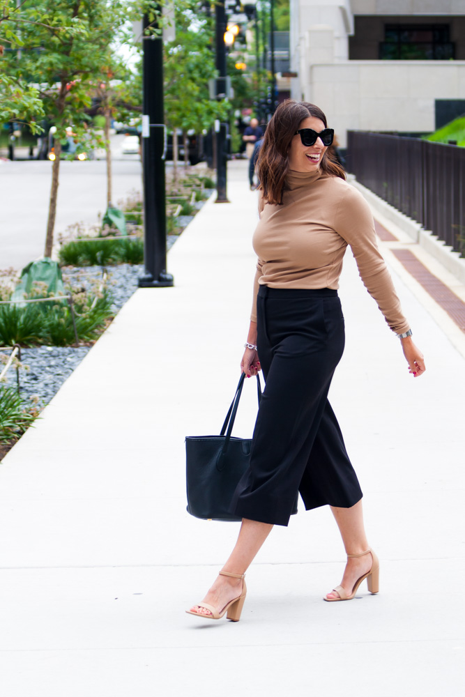 woman wearing brown top and black pants for post pandemic fashion