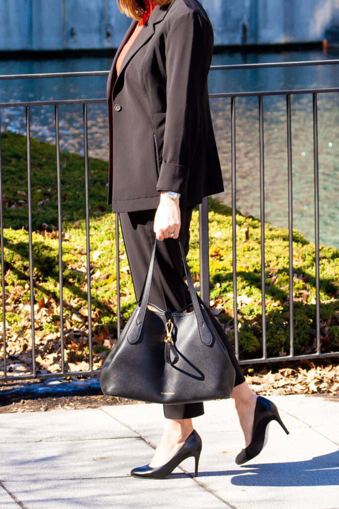 woman walking and wearing suit and red top for post pandemic fashion