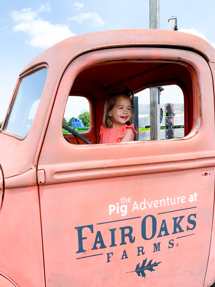 child in a red truck