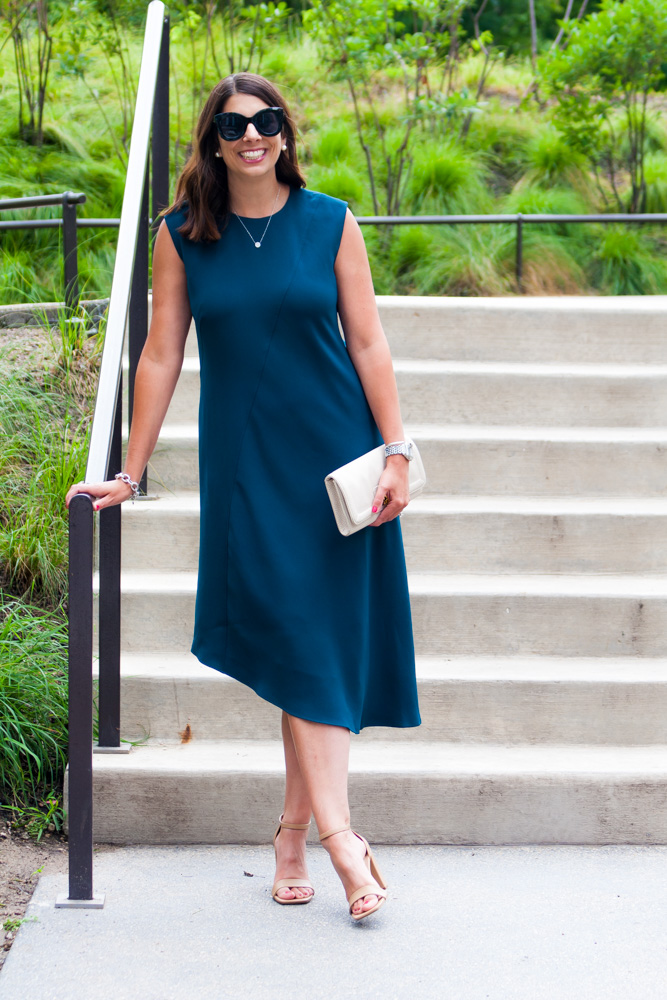 woman leaning on a stairs and explaining wedding guest dress codes