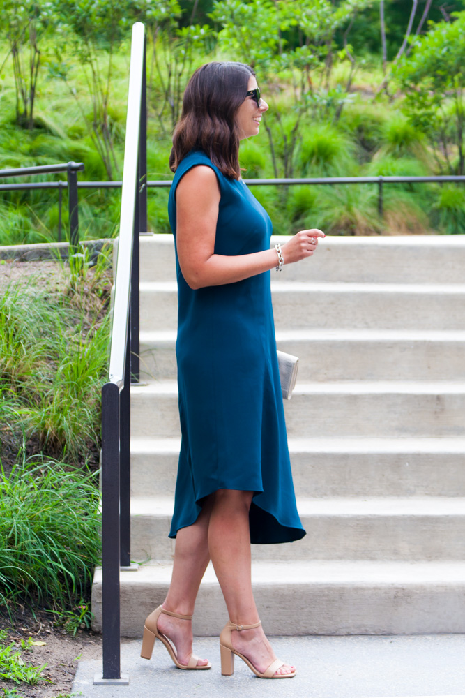 side view of a woman wearing an asymmetric dress 