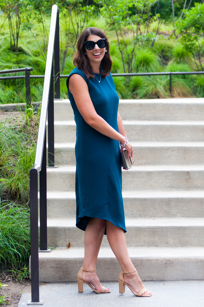 woman wearing asymmetric dress and heels and woman explaining wedding guest dress codes