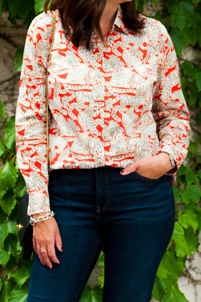 closeup of a woman wearing a bold pattern blouse