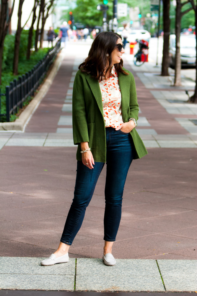 woman wearing bold pattern blouse, green cardigan, and jeans