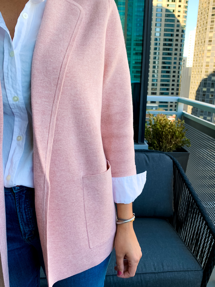 woman wearing whit button down shirt and pink jacket