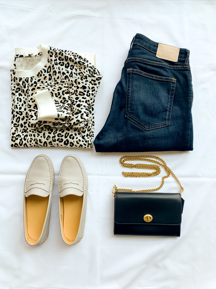 leopard jacket, denim jeans, flats, and black handbag 