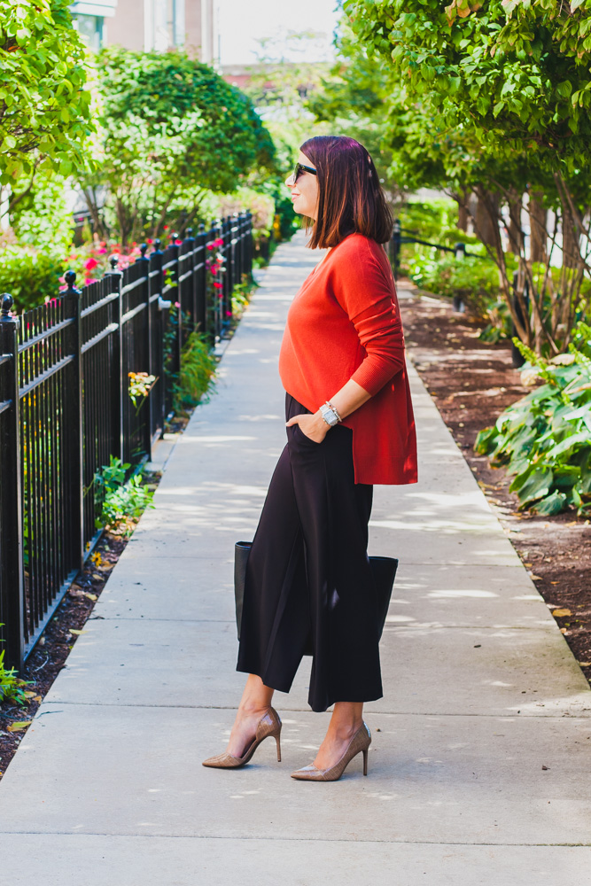 woman wearing pants and red cardigan
