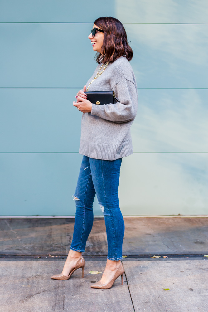 woman wearing plush cashmere sweater, jeans, and pumps