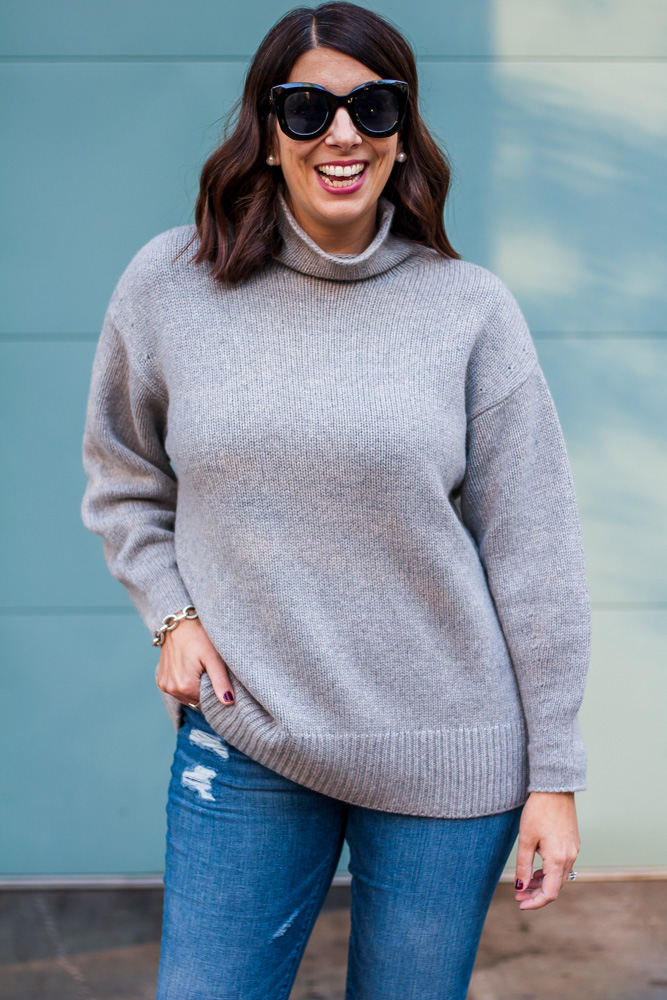 woman smiling and wearing Plush Cashmere Sweater and denim pants