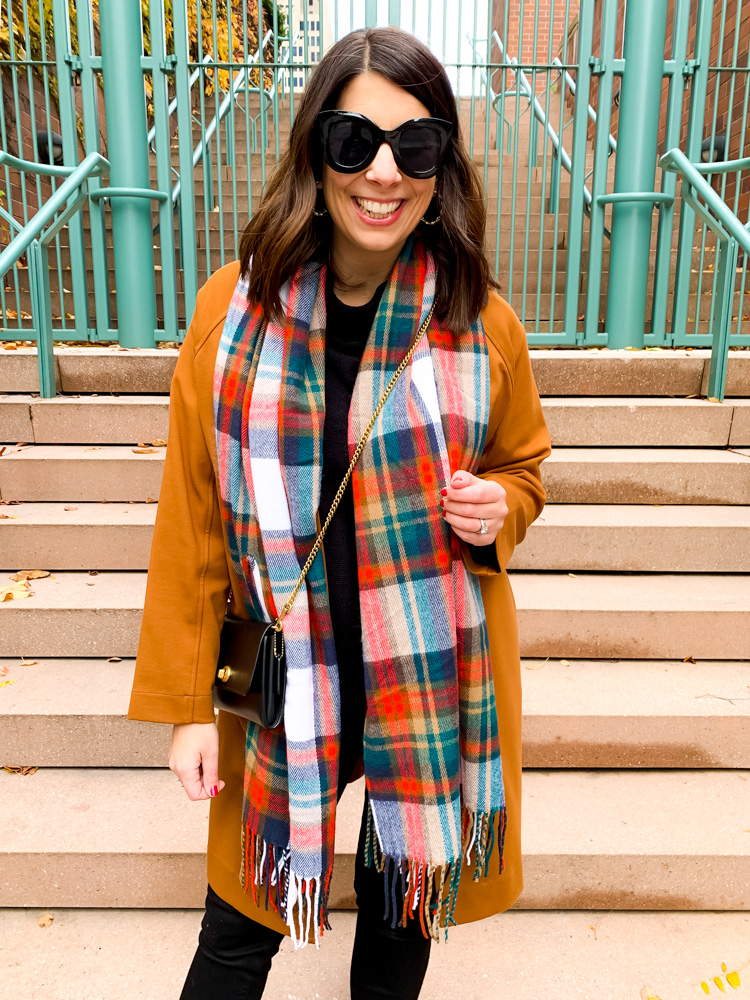 woman smiling and wearing scarf and jacket 