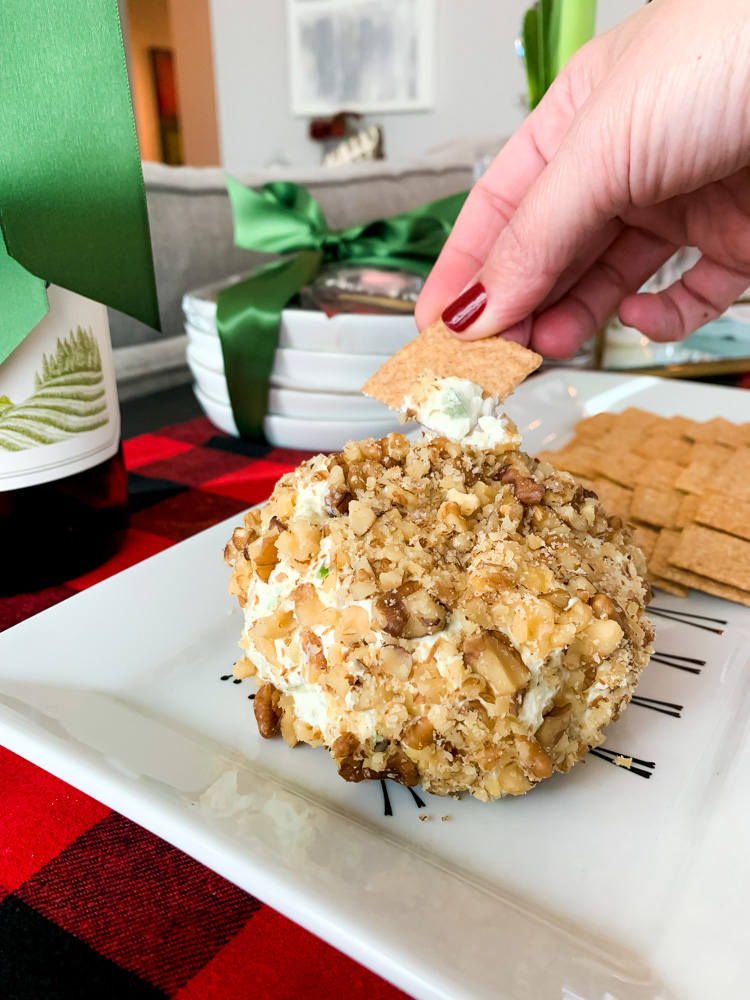 woman dipping in holiday cheese ball recipe