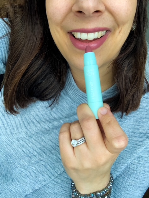 woman using Tarte Cosmetics H₂O Balm Lip Tint