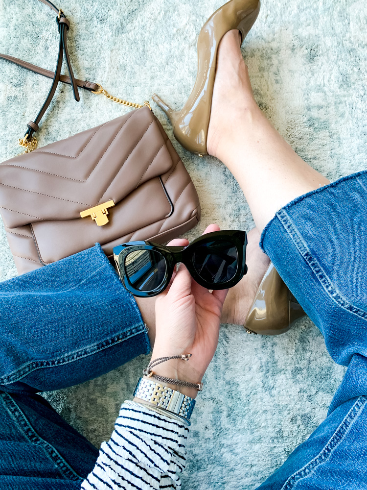 woman holding sunglasses under $30