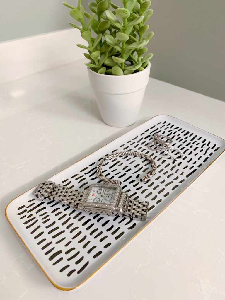 makeup or jewelry tray as primary bathroom essentials 