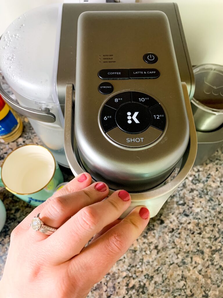 woman using keurig coffee make 