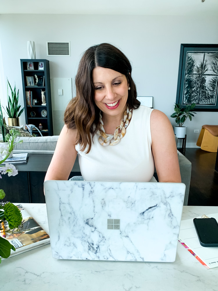 woman wearing work from home uniform using her laptop