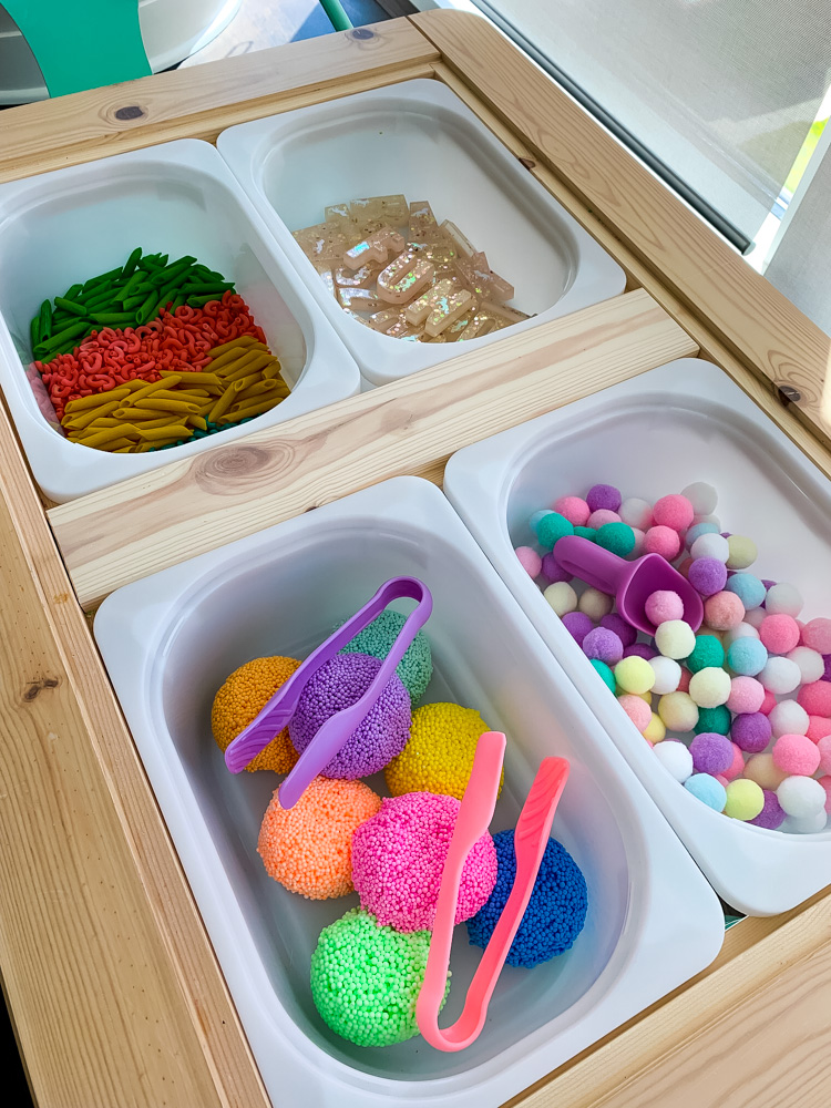 ikea sensory table with colorful items
