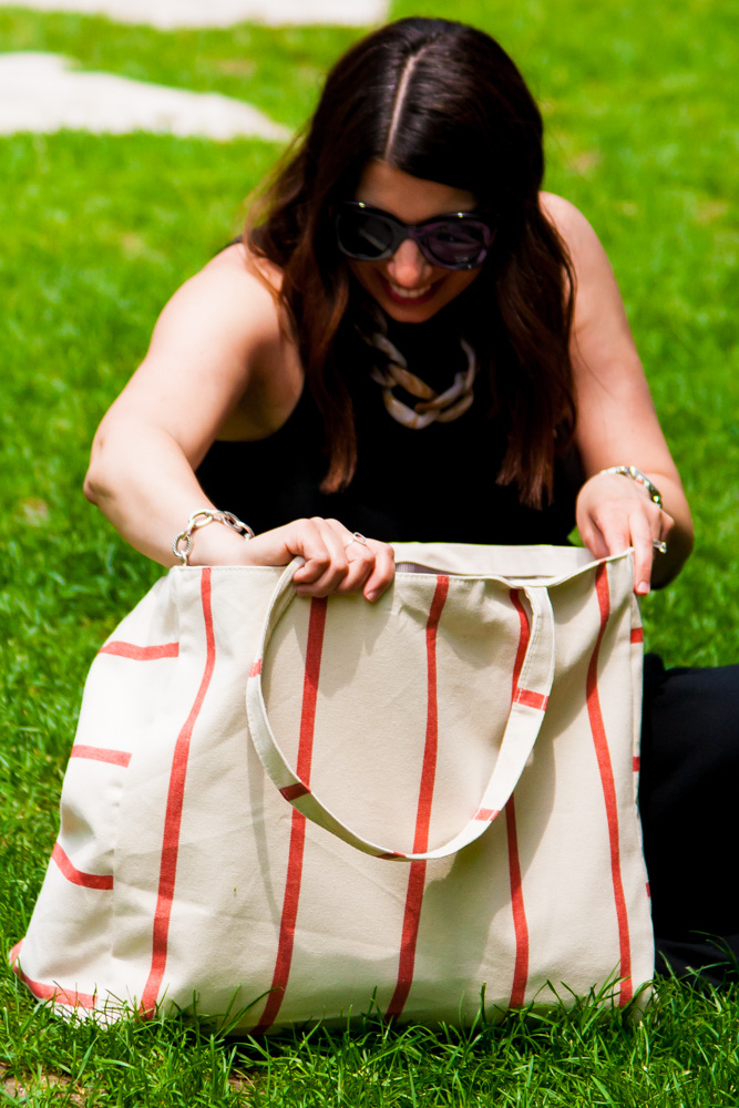 woman looking in her summer tote bag