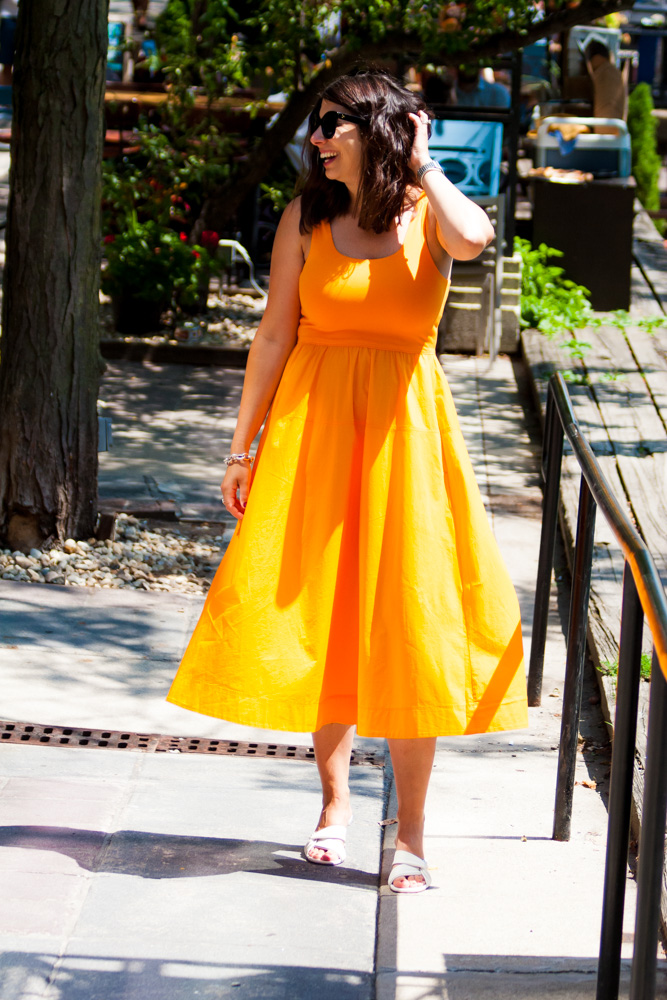 woman in orange dress and wearing a pair of INEZ Shoes 