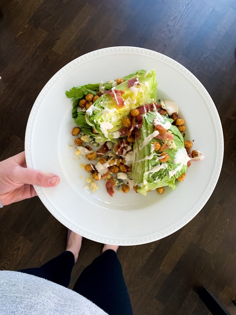 woman showing one of her lunch salads she makes when working from home