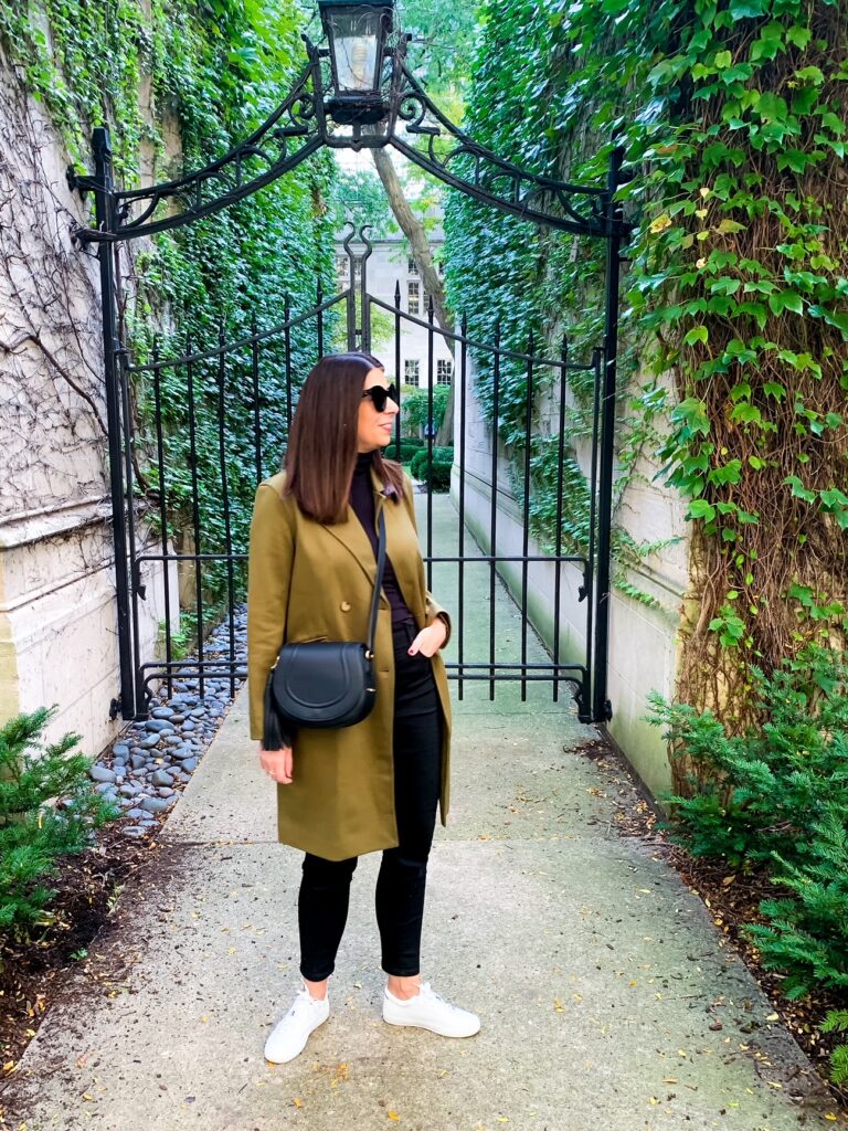 woman showing her black saddle bag