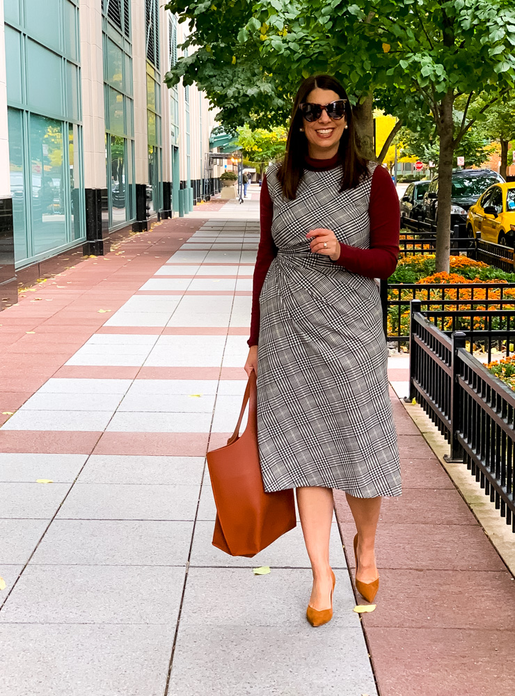 woman showing how to wear plaid this fall and wearing orange shoes