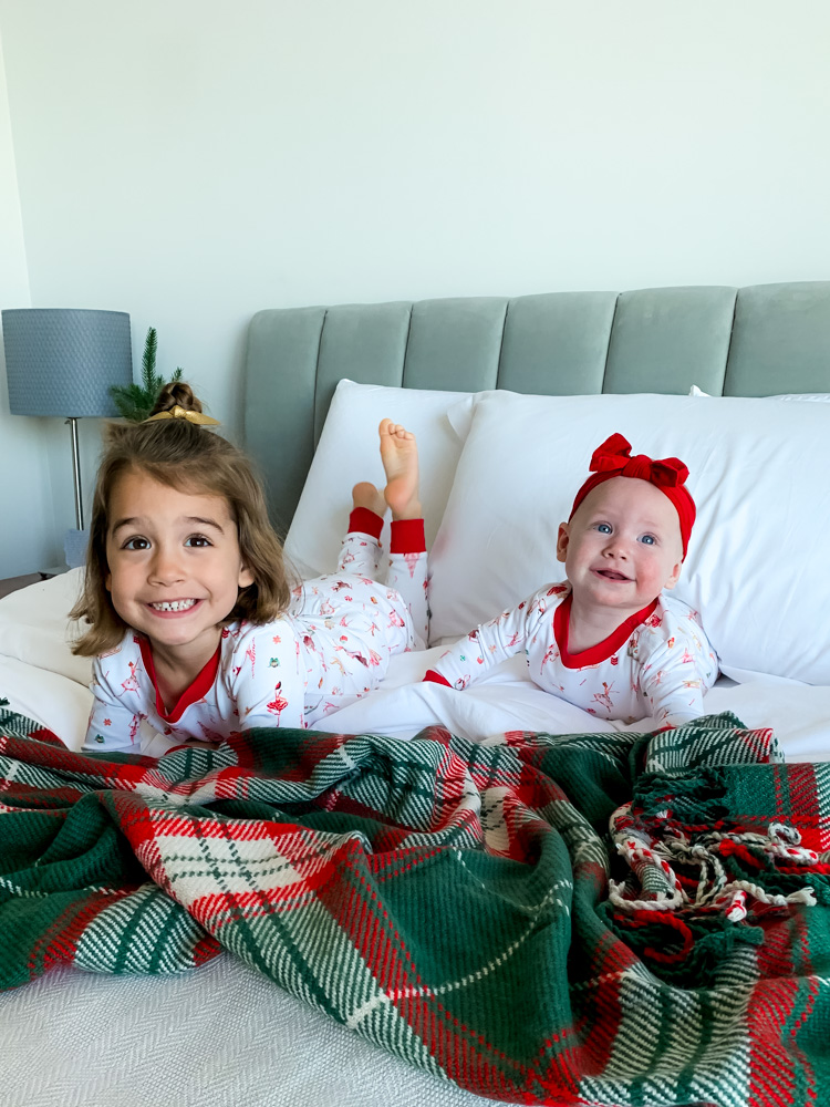 two girls on a bed in their matching christmas pj's