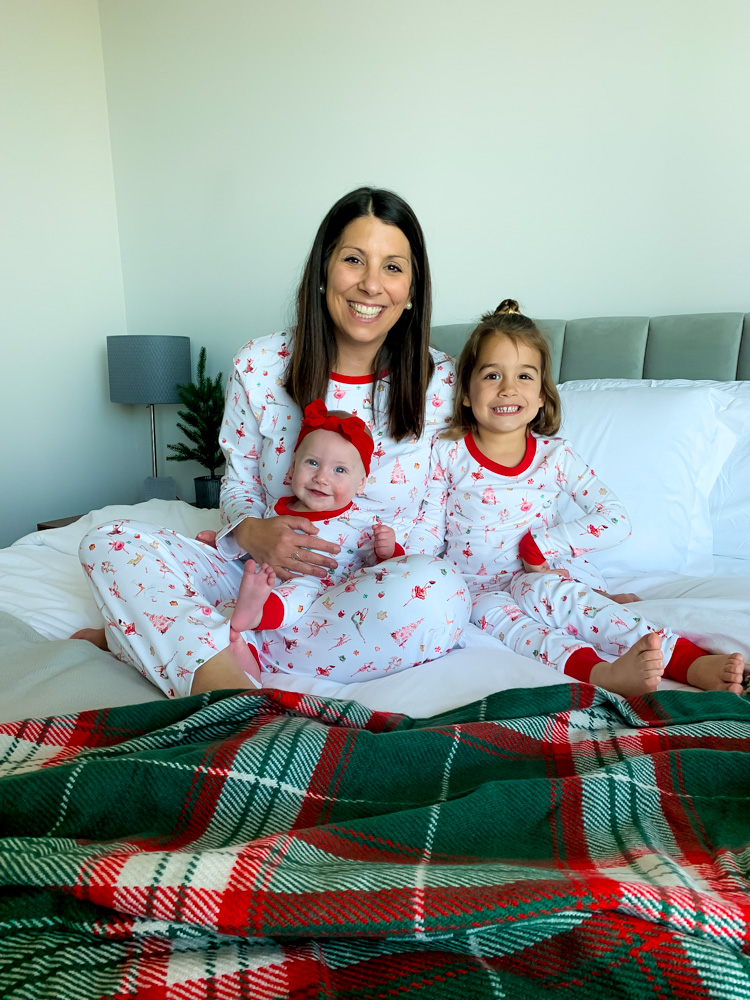 Woman and daughters dressed in matching christmas pj's