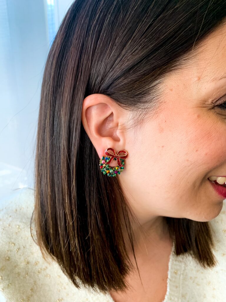 detail of woman wearing earrings as part of her festive holiday outfits