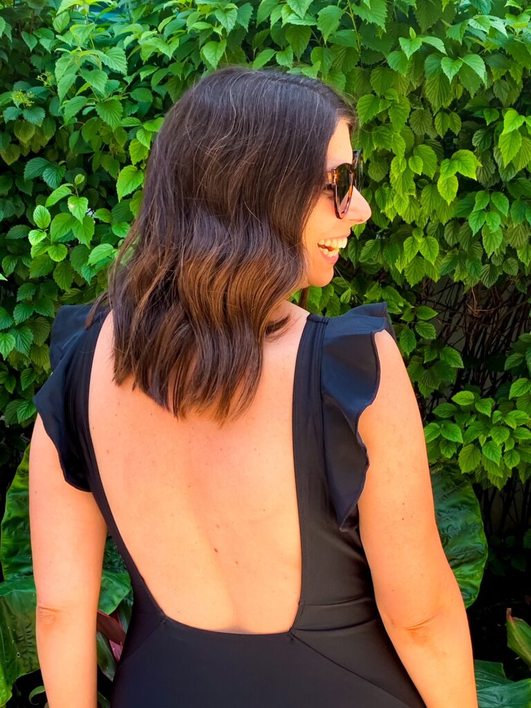 woman showing back detail in the summersalt swimwear review